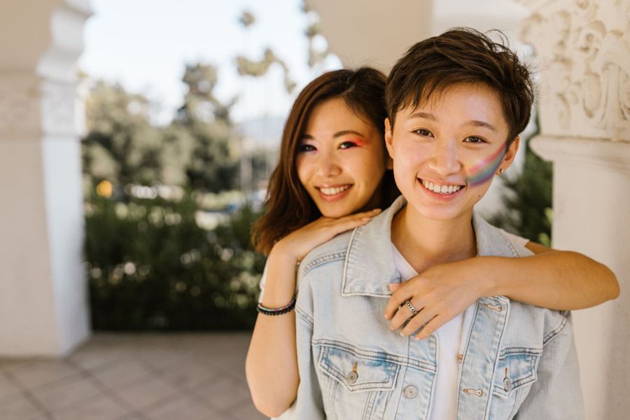 Two women smiling under an arch